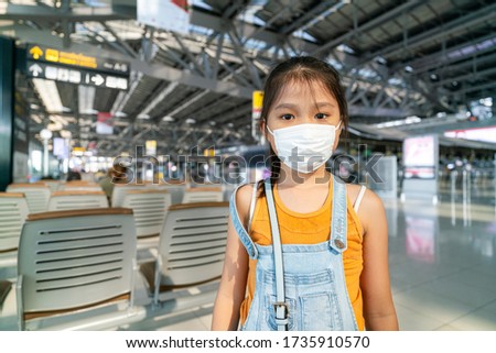 Asian หgirl staying in airport and because flights cancellation status on because coronavirus or covid-19 pandemic effected. airline business crisis concept