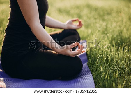 Young caucasian woman practices yoga in lotus position on an early sunny morning in a forest . Healthy lifestyle concept. Morning meditation, relaxation. Soft selective focus.