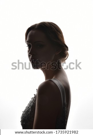 backlight, head and shoulders portrait of a female against white background. Royalty-Free Stock Photo #1735921982