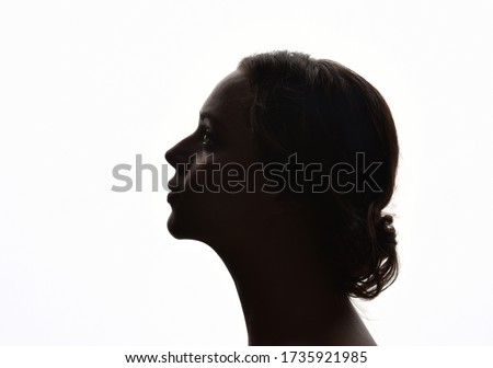 backlight, head and shoulders portrait of a female against white background. Royalty-Free Stock Photo #1735921985