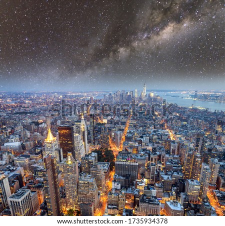 Manhattan skyscrapers at night with milky way, aerial view of New York City.