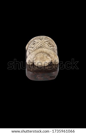 A closeup shot of a turtle statue isolated on the black background