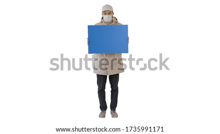 Casual man with copy space billboard wearing protective mask on white background.