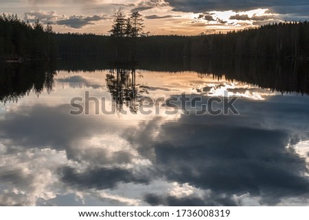 Sunrise over the lake with the reflection in the water, long shutter speed