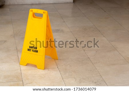 showing warning of wet floor on wet floor