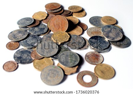 Indian Old vintage coins. Indian old and new coins isolated on white background.  Valid and invalid Indian currencies. Old Indian Currency old Coin - GEORGE VI KING EMPEROR picture highlighted. Royalty-Free Stock Photo #1736020376