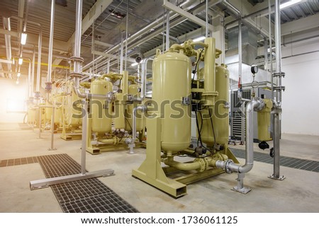 Industrial air compressor systems with equipment machinary, tank, pump, gauge, valve, electric supply, and piping systems into the supply manufactering process of the plant Royalty-Free Stock Photo #1736061125