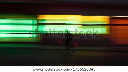 a man is cycling on the dark street