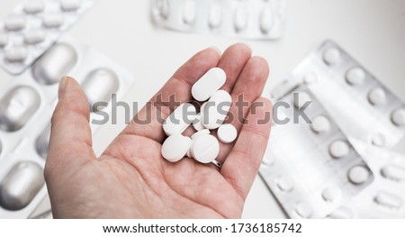 handful of medical tablets in the palm of your hand for the treatment of diseases Royalty-Free Stock Photo #1736185742