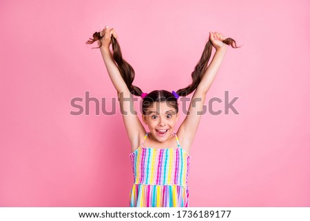 Photo of pretty beautiful little lady raise hold hands two cute curly tails up showing long length new shampoo effect wear colored summer dress isolated pastel pink color background