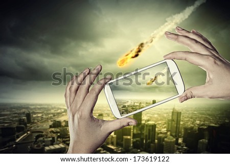 Close up of human hands taking photo of falling meteorite