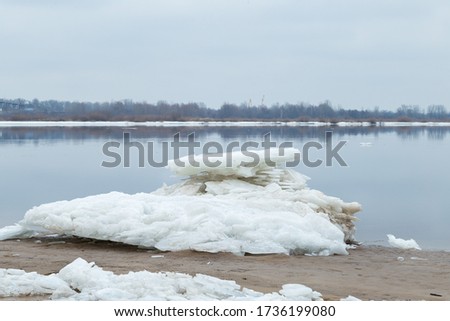 A white block of ice on the shore