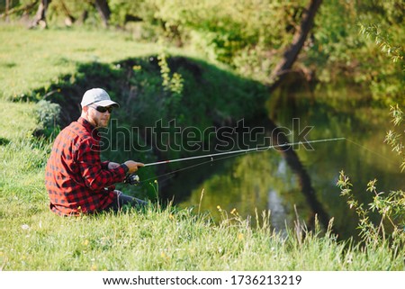 Man relaxing and fishing by lakeside. Weekends made for fishing. Fisher masculine hobby. Master baiter. Keep calm and fish on. Fishman crocheted spin into the river waiting big fish. Guy fly fishing