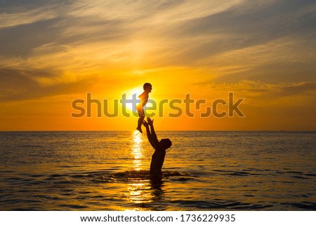 Happy family on the background of the sunset on the sea of Azov