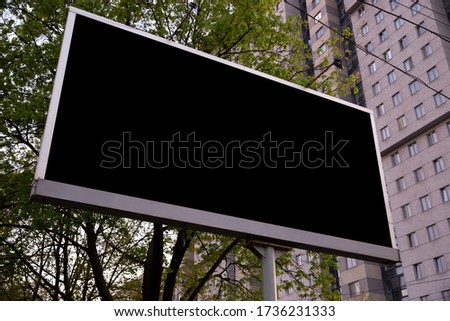 Blank billboard for advertising at the city around, copyspace for your text, image, design. Media marketing, ads, promo announcement, commercial propose or message. Banner, template black.