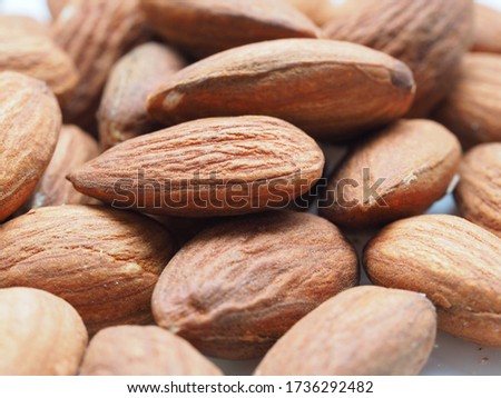 Roasted almonds in close up view showing the texture and pattern on the brown kernel