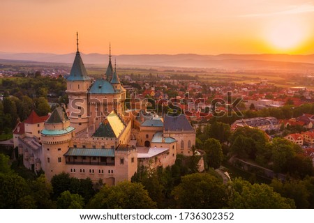 Aerial view of Bojnice medieval castle, UNESCO heritage in Slovakia. Romantic castle with Gothic and Renaissance elements built in 12th century. Early morning sunrise golden hour.