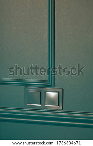 Electrical household navy blue switches in minimalist interior design. Stylish bedroom and livingroom door handle. Wooden parquet room. Interior room mockup. Scandinavian style.