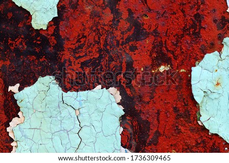 Old dried paint on rusty steel surface, red, blue,