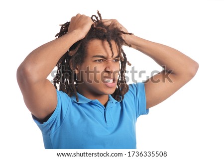 Portrait of angry teenage boy posing isolated on white background