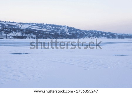 winter scenery with village and frozen lake