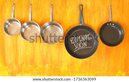 Restaurant announcing reopening after the corona lockdown,gastronomy business conceptual picture with kitchen utensils and reopening message 