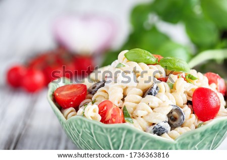 Pasta Salad with freshly chopped basil, tomatoes, black olives, red onion and Feta cheese, tossed with an Italian oil dressing. 