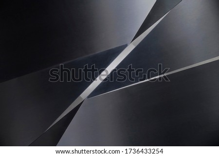 Steel panels or sheets with slots between them. Abstract modern architecture and industrial background. Fragment of hi-tech building with polygonal geometric structure in shades of metallic gray color