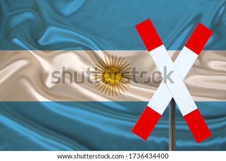 sign, stop, attention on the background of the silk national flag of Argentina, the concept of border and customs control, violation of the state border, tourism restrictions