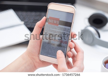 Online news about coronavirus on a mobile phone. Close up of businesswoman reading news or articles in smartphone screen application. Hand holding smart device. Site layout. Newspaper