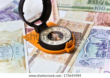 Banknotes and compass. Navigation in the world of Finance. On a white background are old banknotes, is a compass.