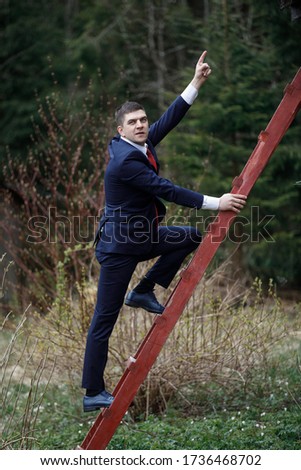The man on the stairs. A man in a suit climbs up. Business Climbing.
