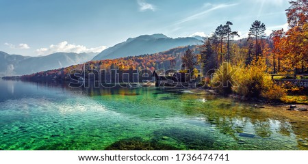 Wonderful Vivid nature scenery. Fantastic views of the turquoise alpine lake, Trees and majestic mountains, under sunlight. Amazing nature mountain landscape. beautiful background for design and post