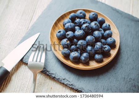 Blueberries on a dark background on a plate