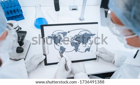 close up. map of the spread of coronavirus in the hands of an epidemiologist. Elements of this image furnished by NASA Royalty-Free Stock Photo #1736491388
