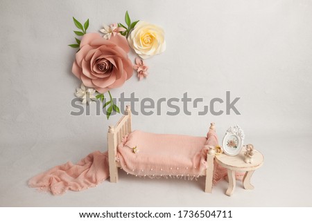 Spring pastel flowers next to baby bed with decor in white baby's room, copy space concept. Stylish baby bed near light wall in interior of children's room. Bucket of flowers Royalty-Free Stock Photo #1736504711