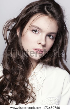  Portrait of young girl with curly hair Young girl. Beautiful teenager. Youth and healthy beauty. Beautiful hair. Portrait of a teen.