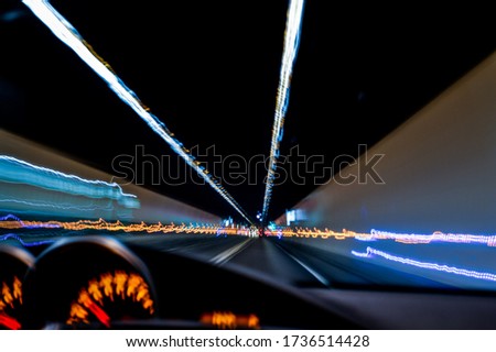 Drunk driving. View from eyes of a drunken driver. Long exposure picture of lights on a tunnel while driving.