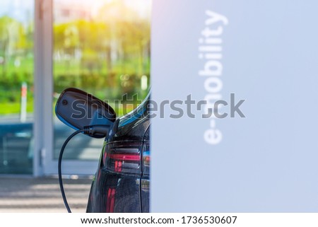 Socket plug with charging for electric car, battery charging close up view. Gas electricity station