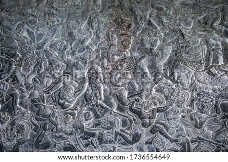Fragment of a bas-relief on the wall of the southern gallery of the  Angkor Wat temple, depicting an ancient battle scene, Siem Reap, Cambodia