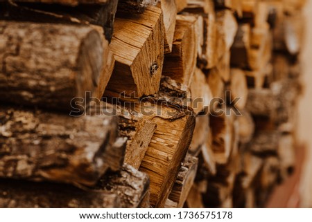 A bunch of wooden hacked firewood laying outside