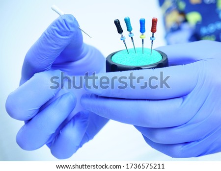 An endodontist physician places the endodontic instruments in a sterile box. A set of hand tools placed in a sterile box. Royalty-Free Stock Photo #1736575211
