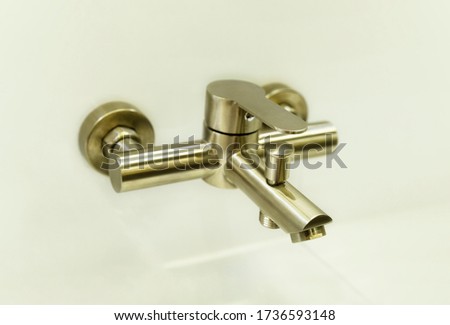 Bronze metal water tap of modern design.Faucet. Selected focus. Bathroom