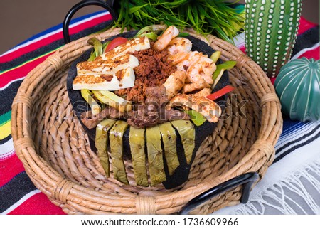 Molcajete with vegetables meat and cheese Royalty-Free Stock Photo #1736609966