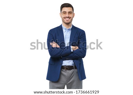Young teacher wearing blue blazer, casual shirt and trousers, holding arms crossed, looking at camera with confident happy smile, isolated on white background Royalty-Free Stock Photo #1736661929