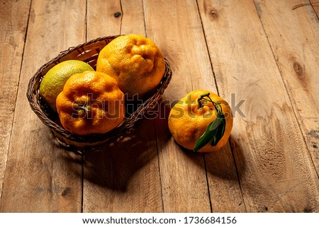 murcott tangerine, brazilian fruit on wooden table in basket
