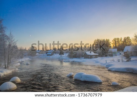 Winter, noisy river in the village.Karelia.
