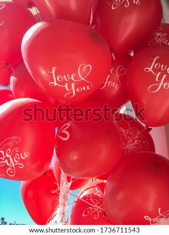 Close up of a bunch red heart shaped balloons with "i love you" text on them. Valentine's day concept vertical stock image.