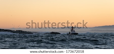 Boating at sunset in Atlantic ocean, South Africa 