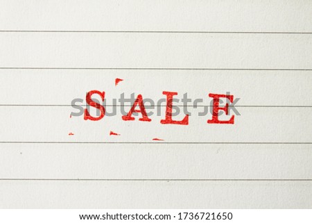 The red word sale stamped on a white lined paper. Price reduction and promotion in trade and services concept photo.